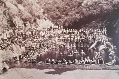 Historic black and white photograph of a crowd of swimmers at St John's Pool